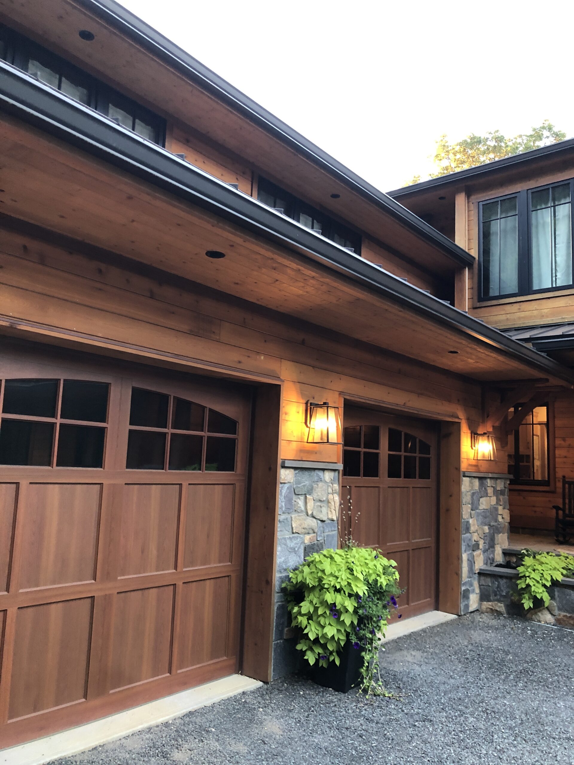 Two door garage in a modern rustic exterior of a cabin-style home